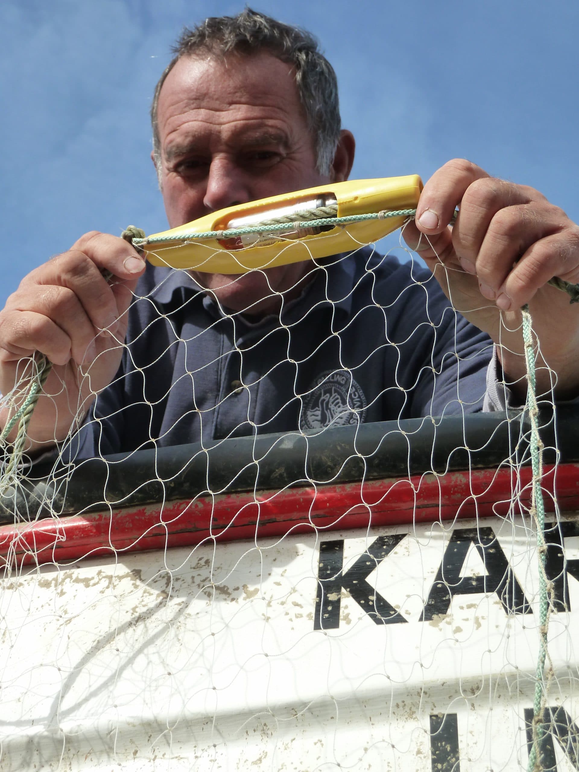 A fisher holds a pinger