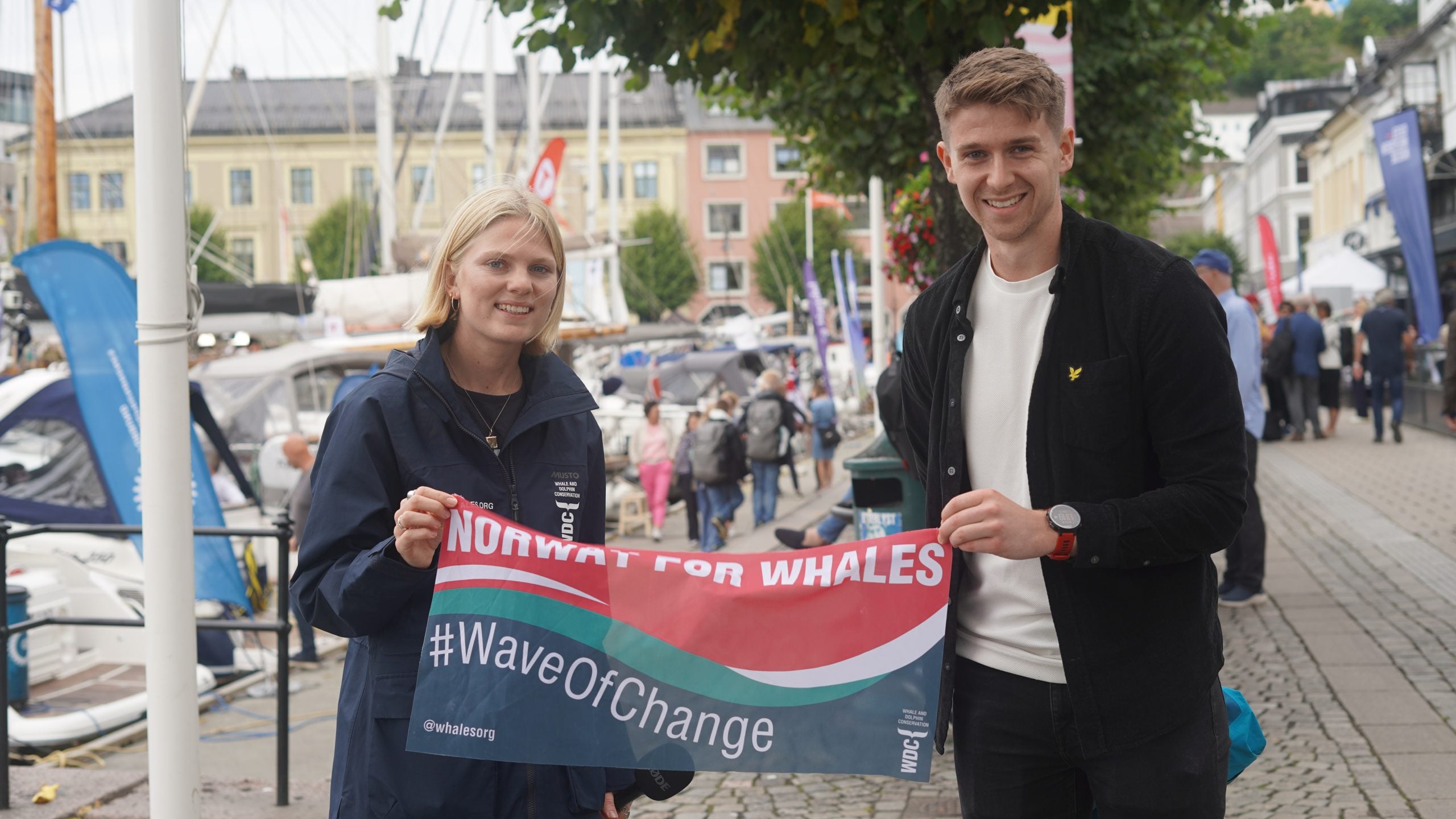 Stop Whaling campaigner Lottie with young Norwegian holding a Norway For Whales banner