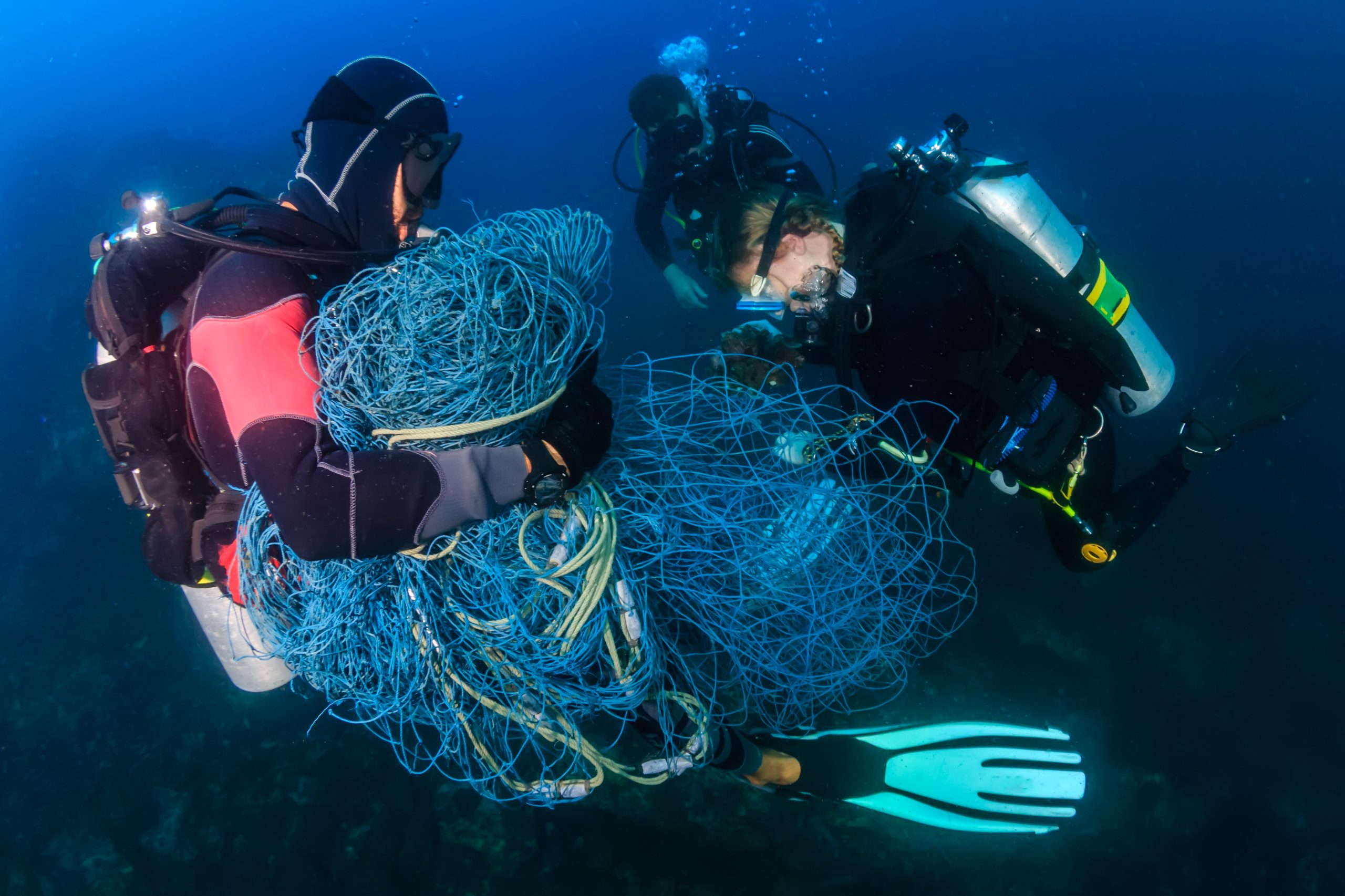 Two scuba divers retriving ghost gear